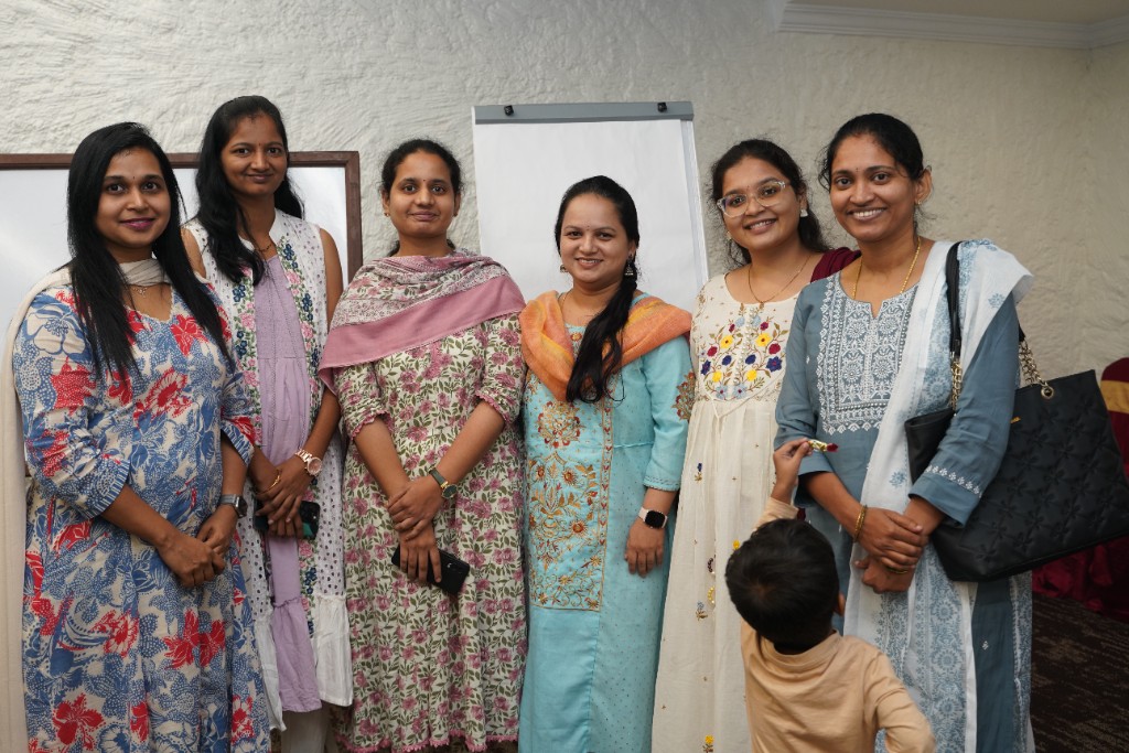 NAPA members in colourful attire together at an indoor gathering
