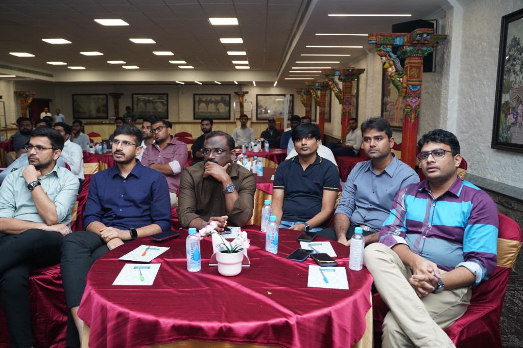 Session with attendees seated at round tables