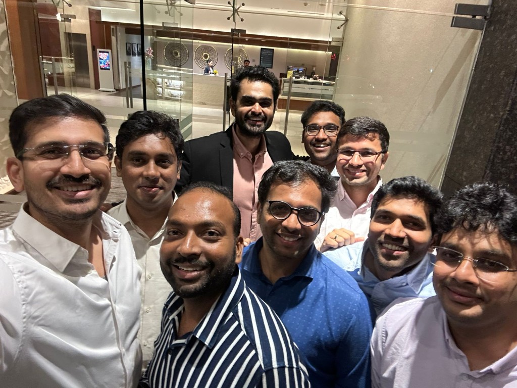 Colleagues together for a group photo in a bright lobby