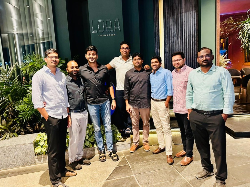 Group posed outside LOBA Cocktail Room during an evening networking dinner