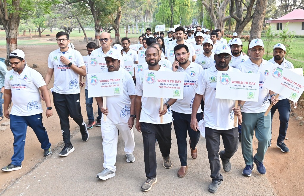Walkathon participants in white shirts advancing together